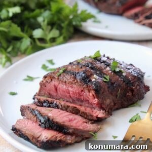 sliced grilled steak on plate with fork