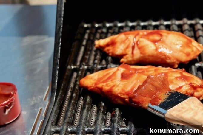 10 Essential Grilling Tips and Tricks for Perfect BBQ 7 brushing bbq sauce on chicken on grill