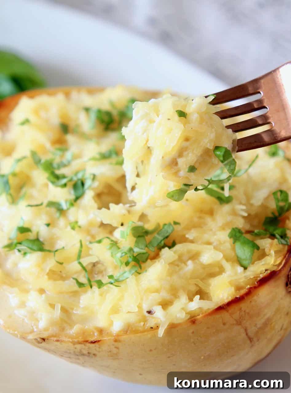 Baked Spaghetti Squash Mac and Cheese 2 Spaghetti squash mac and cheese in a squash shell with fork dipped into the squash