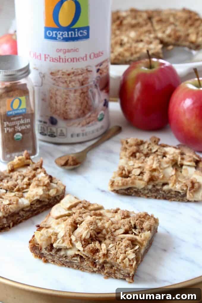 apple oatmeal bars on marble serving tray with apples