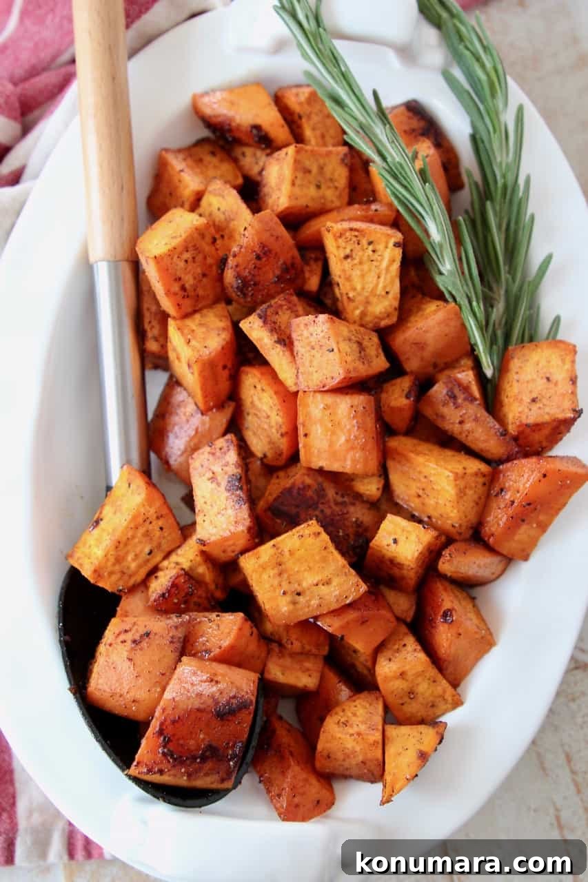 roasted cubed sweet potatoes in bowl with serving spoon