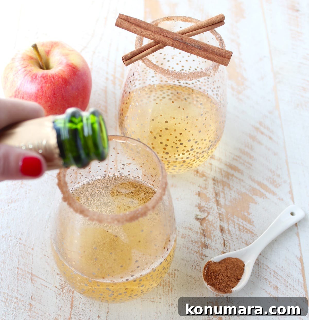 Rich apple cider is paired with sparkling champagne, vodka, maple syrup, cinnamon and nutmeg to make a festive fall apple cider champagne cocktail!