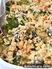 broccoli casserole with ritz cracker topping in dish with serving spoon