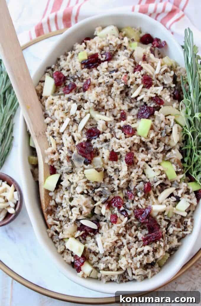 Wild Rice Pilaf with Apples and Cranberries 2 overhead image of wild rice pilaf in serving dish with wooden serving spoon