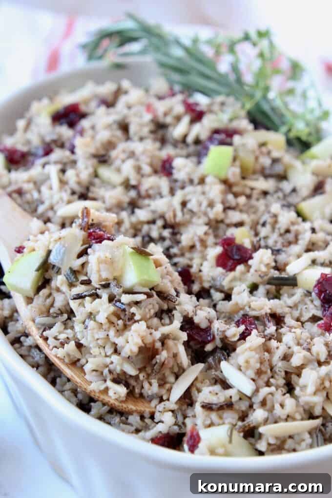 Wild Rice Pilaf with Apples and Cranberries 5 rice pilaf in serving dish with wooden serving spoon
