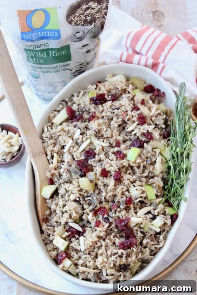 Wild Rice Pilaf with Apples and Cranberries 6 cooked wild rice pilaf in serving dish with spoon and fresh herbs