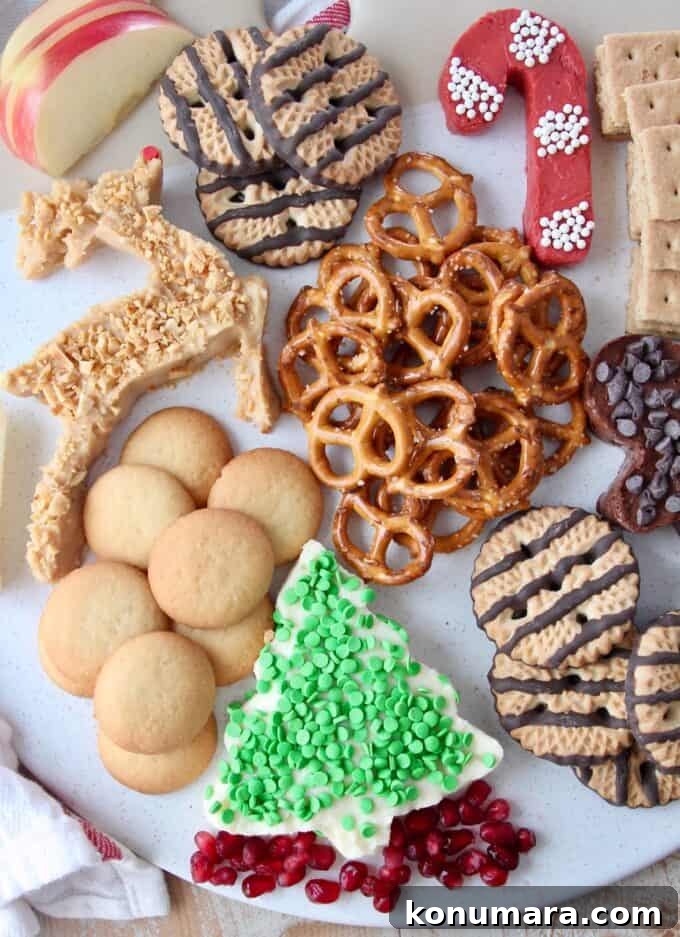 Overhead image of holiday dessert board with pretzels and cookies