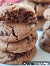 Double Chocolate Chip Cookies with Fudgy Centers 6 chocolate cookies stacked up on plate