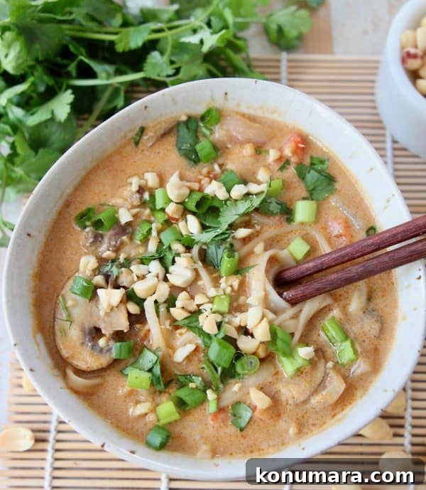 20 Must-Try Recipes from 2020 17 Overhead image of a bowl of Thai noodle soup topped with diced green onions and fresh cilantro