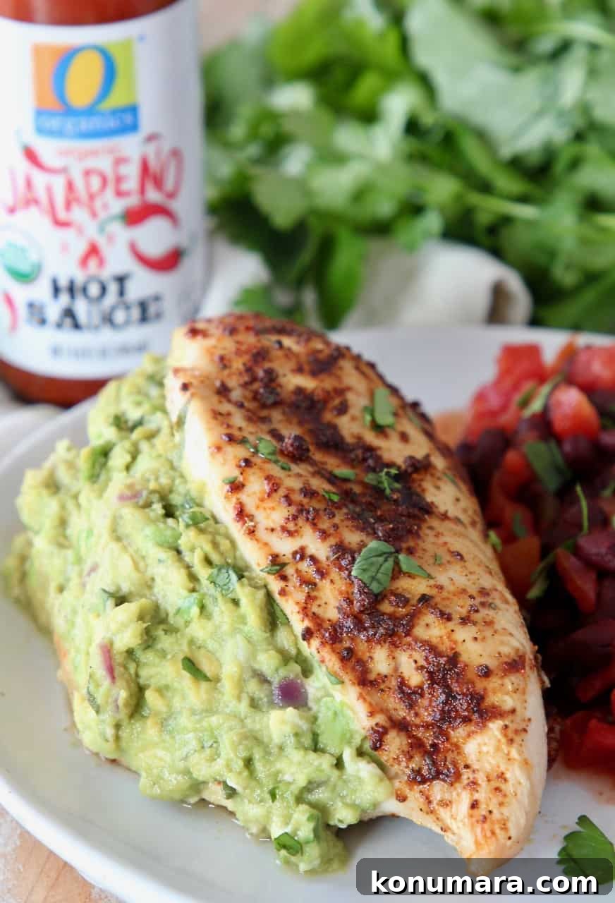 guacamole stuffed chicken breast on plate with black beans