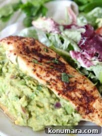 guacamole stuffed chicken on plate with salad