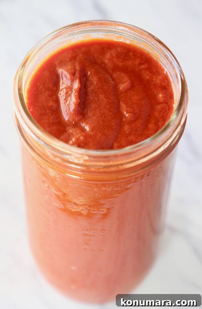 red enchilada sauce in tall mason jar