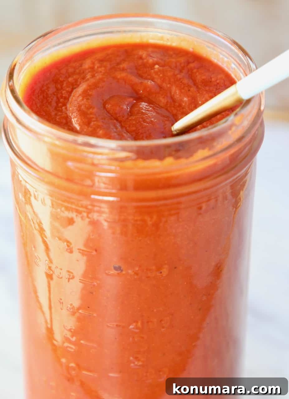 spoon in mason jar of enchilada sauce