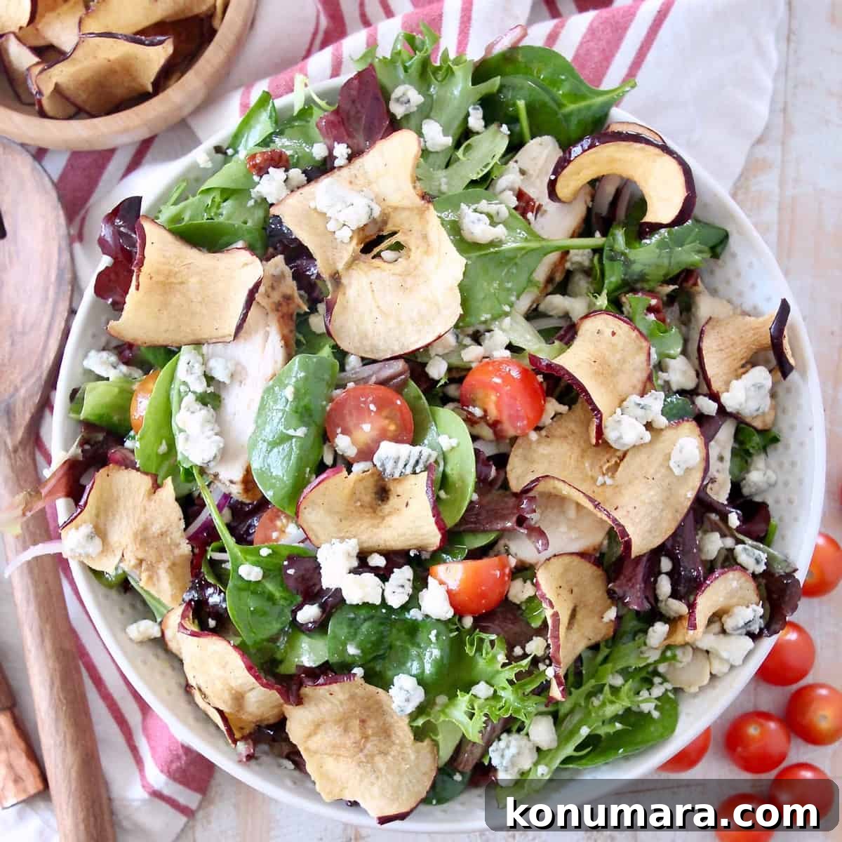 Panera-Style Fuji Apple Chicken Salad Recipe 4 salad in bowl with apple chips and cherry tomatoes