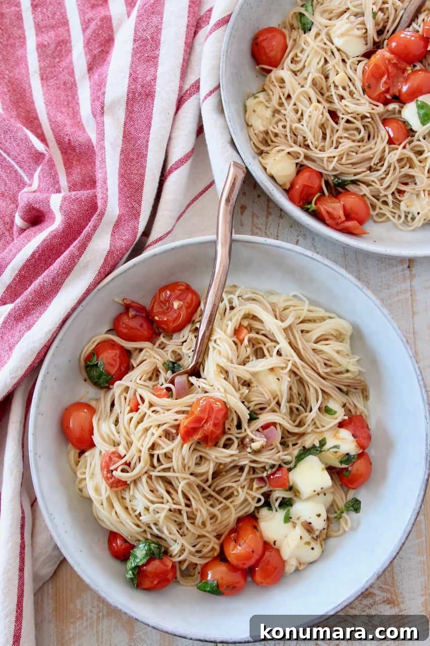 Caprese Pasta with Cherry Tomatoes, Mozzarella and Basil 2 angel hair pasta in bowls with cherry tomatoes and mozzarella cubes