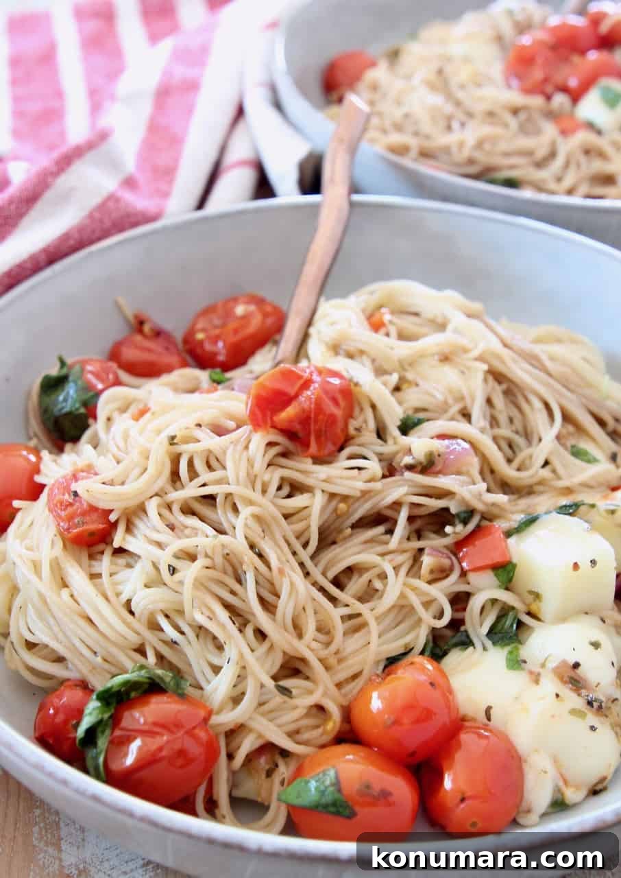 Caprese Pasta with Cherry Tomatoes, Mozzarella and Basil 12 caprese pasta with angel hair pasta in bowl with fork