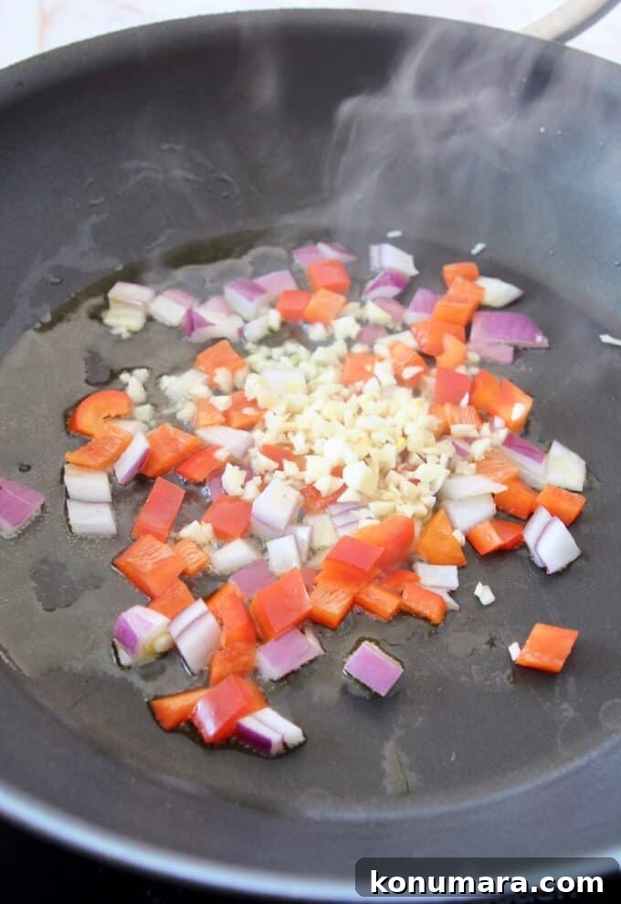 Caprese Pasta with Cherry Tomatoes, Mozzarella and Basil 6 diced onion, pepper and garlic sautéing in skillet