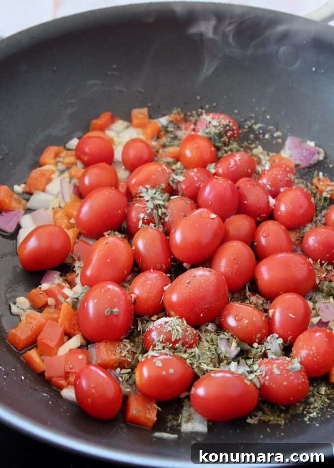 Caprese Pasta with Cherry Tomatoes, Mozzarella and Basil 7 cherry tomatoes with seasonings in a large skillet