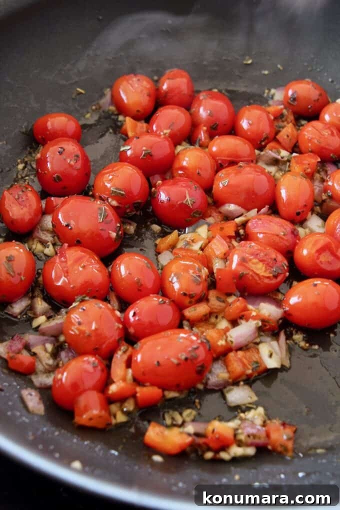 Caprese Pasta with Cherry Tomatoes, Mozzarella and Basil 8 cooked cherry tomatoes with diced onions and peppers in a large skillet