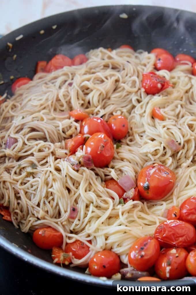 Caprese Pasta with Cherry Tomatoes, Mozzarella and Basil 10 cooked angel hair pasta in a skillet tossed with seasoned cherry tomatoes
