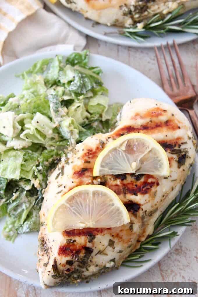 overhead image of chicken breast with slices of lemon