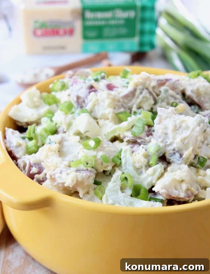 Instant Pot Cheddar Ranch Potato Salad Recipe 5 potato salad with celery and green onions in yellow bowl