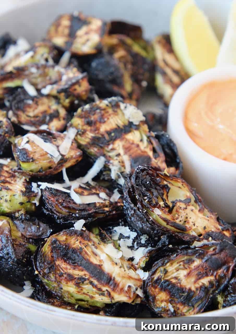 grilled brussels sprouts in bowl with dipping sauce