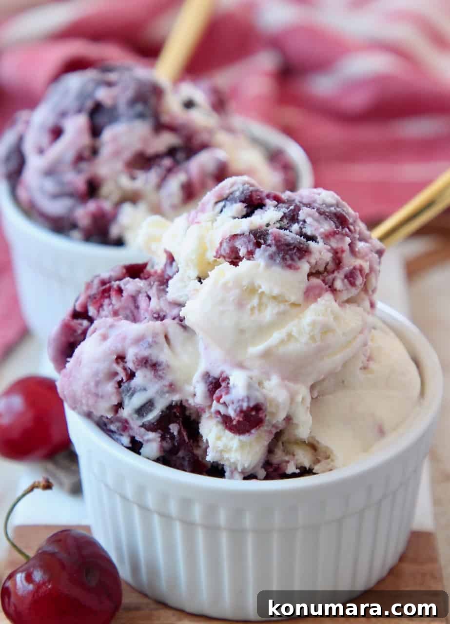 No-Churn Cherry Garcia Ice Cream Recipe 10 scoops of cherry ice cream in white bowl with gold spoon