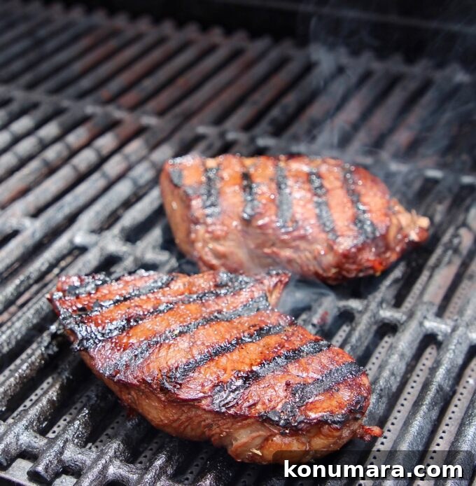 two sirloin steaks on grill