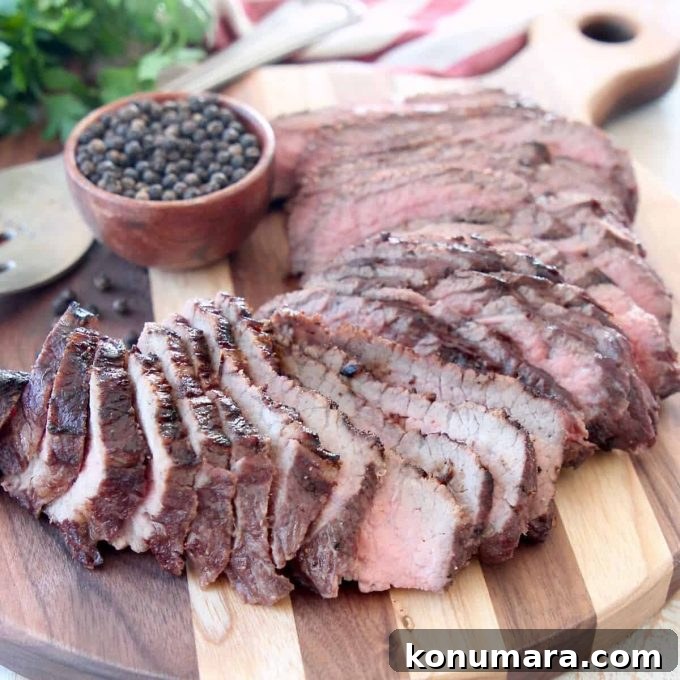 Sliced grilled tri tip on wood cutting board