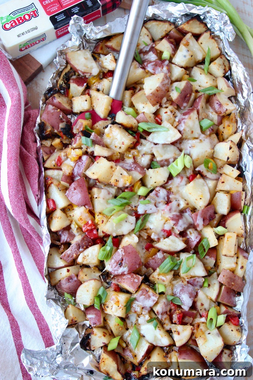 grilled diced potatoes in foil with spatula