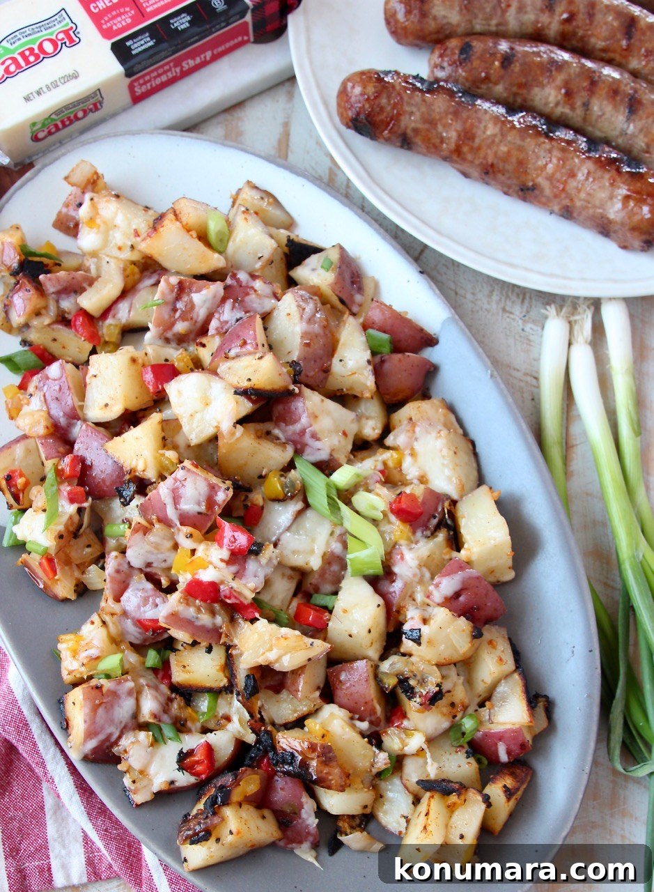 grilled potatoes on plate, next to plate of grilled bratwurst