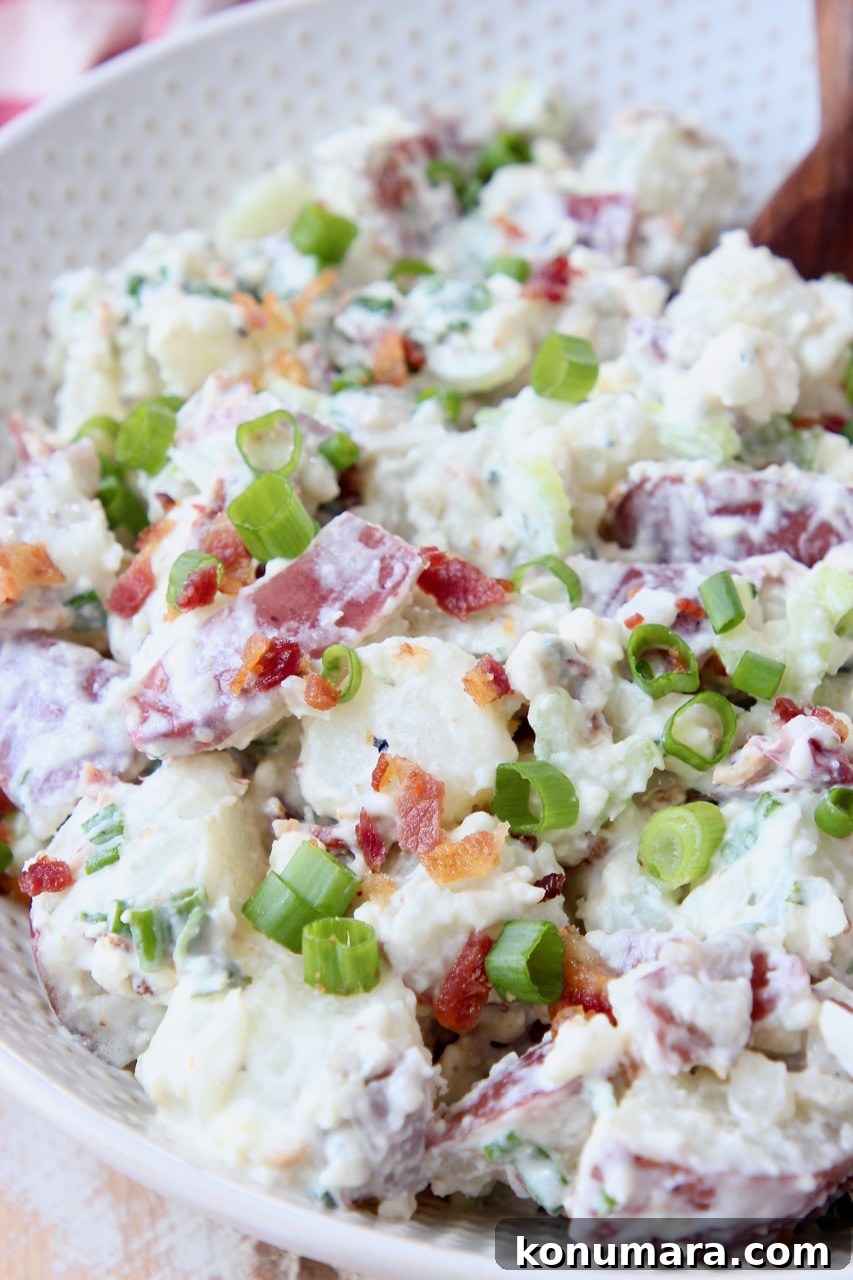 potato salad with bacon and green onions in bowl