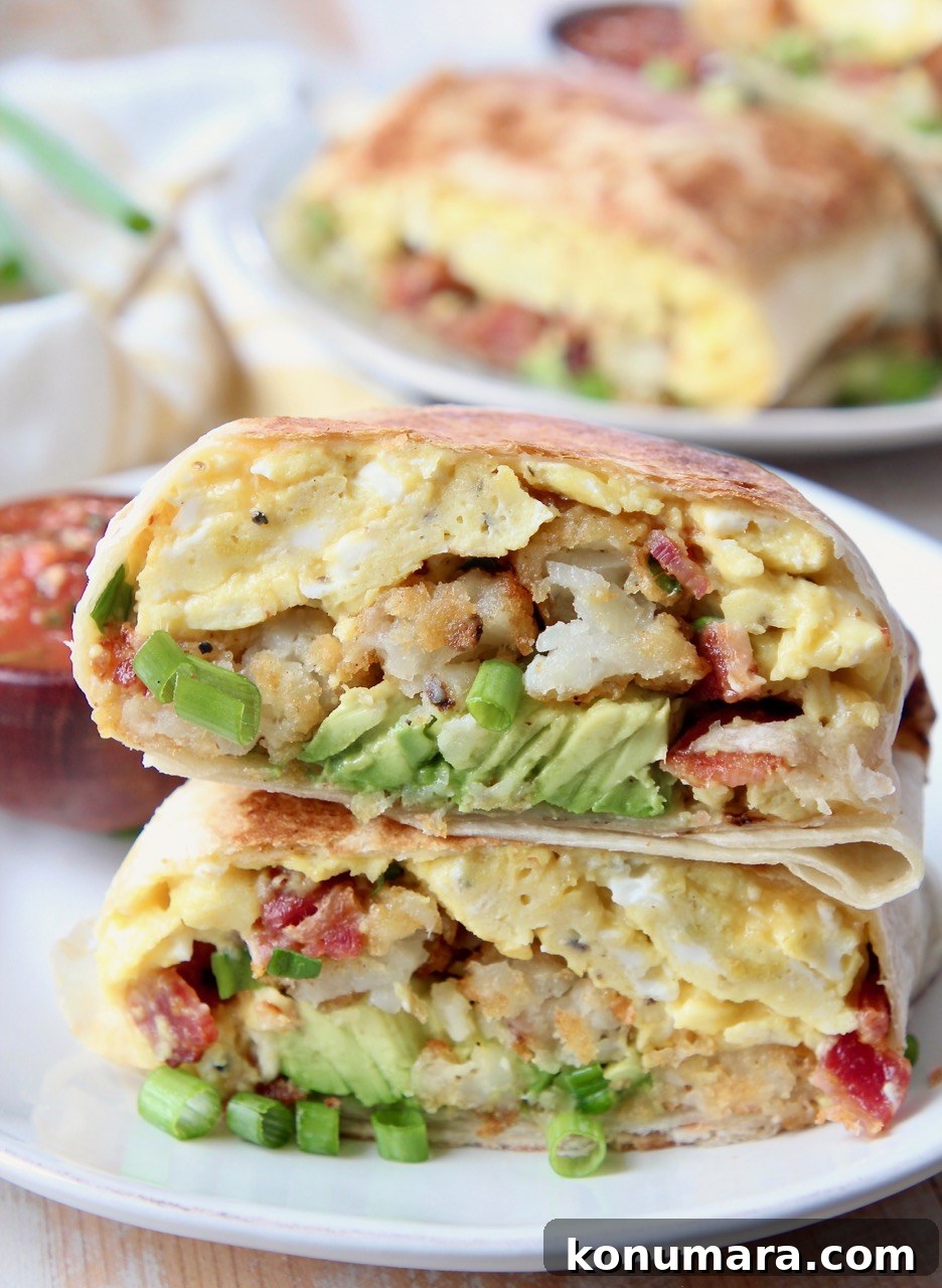 breakfast burrito sliced in half on plate