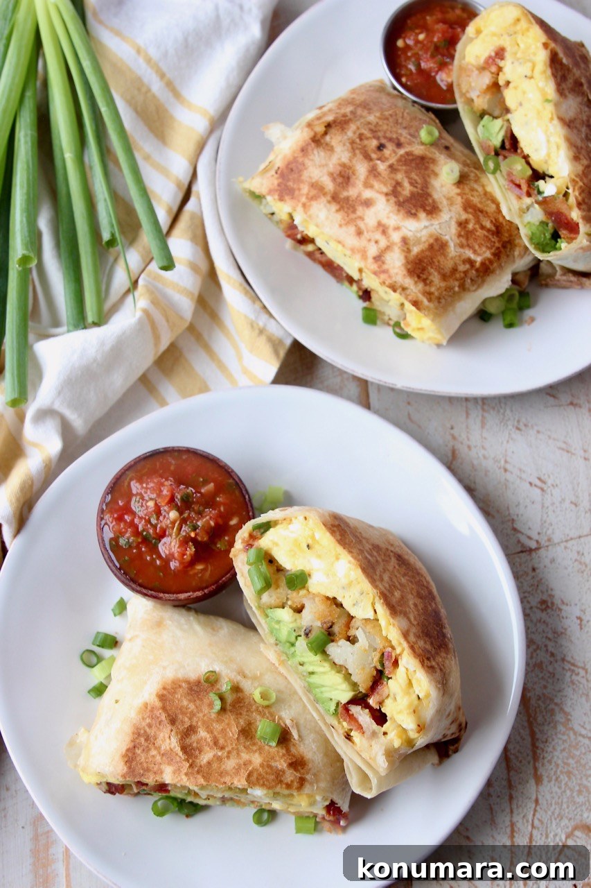 overhead image of breakfast burritos on white plates with small bowls of salsa