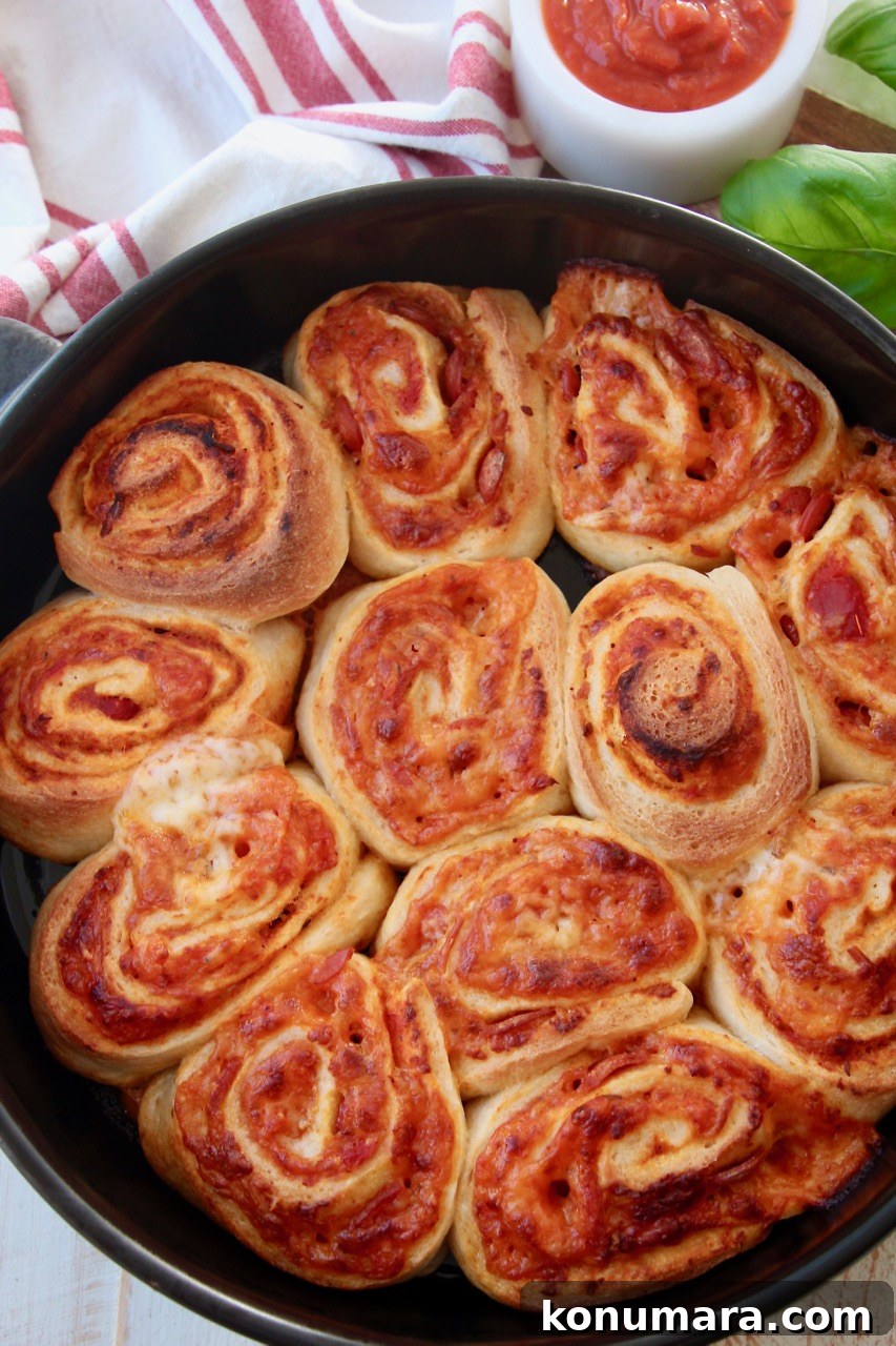 Crispy Homemade Pizza Rolls with Gooey Cheese 2 cooked pizza rolls in pan