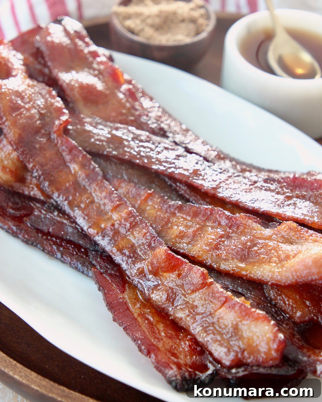 Sweet and Crispy Candied Bacon Recipe 5 cooked candied bacon piled up on white plate