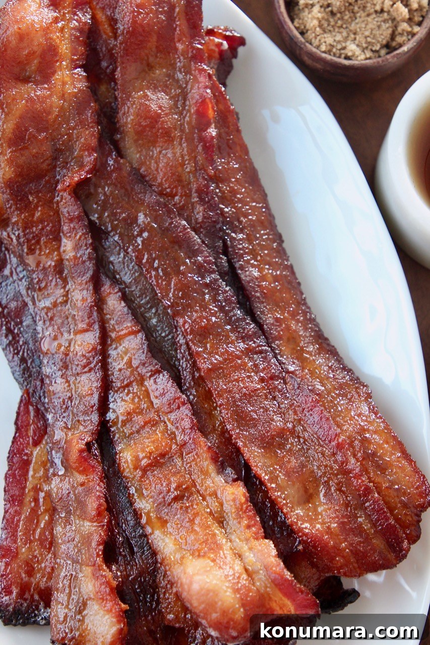 Sweet and Crispy Candied Bacon Recipe 6 slices of cooked bacon on white plate