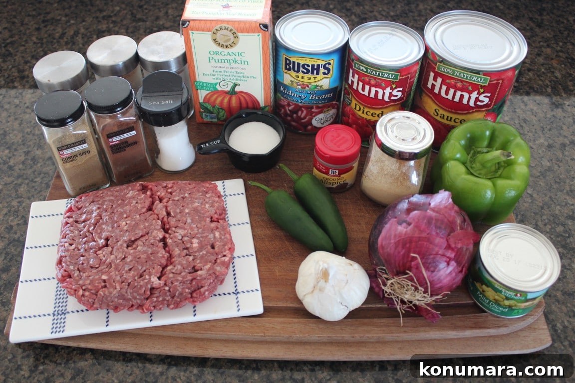 Pumpkin Chili Recipe with Black Beans 3 Pumpkin Chili Ingredients on a wooden cutting board.