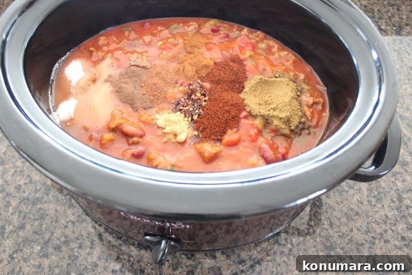 Pumpkin Chili Recipe with Black Beans 9 Spices on top of chili in slow cooker
