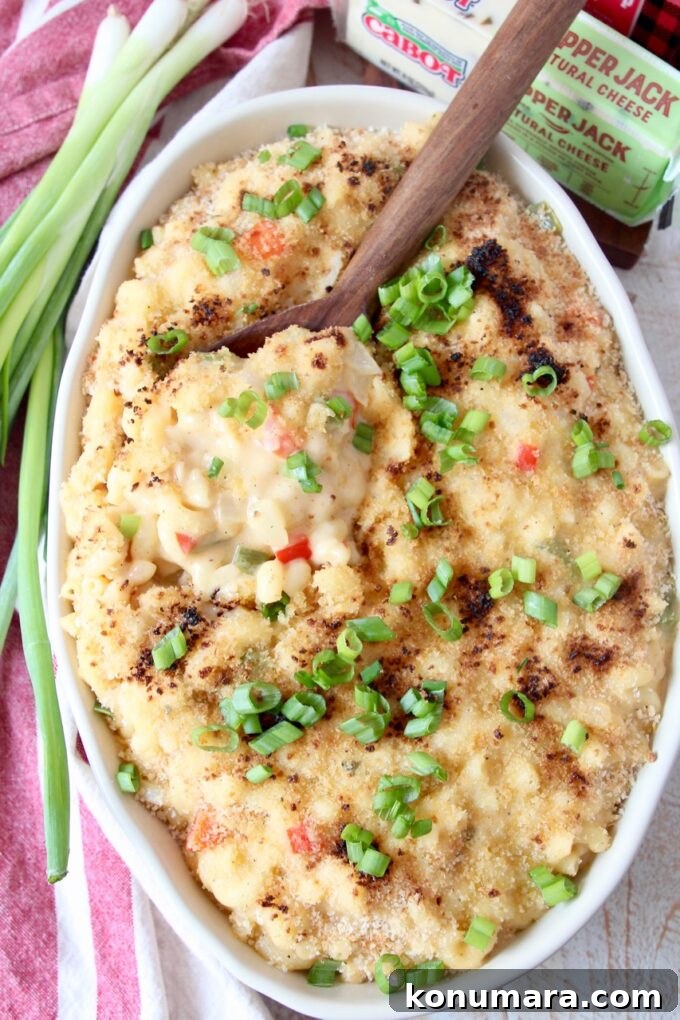 mac and cheese in oval serving dish with spoon