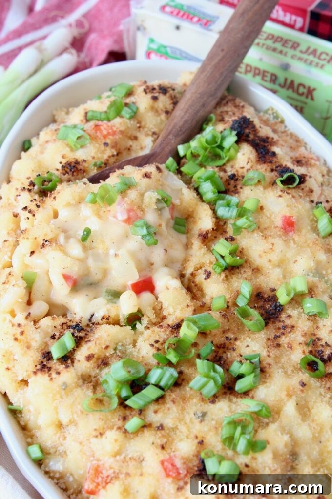 mac and cheese topped with diced green onions in bowl
