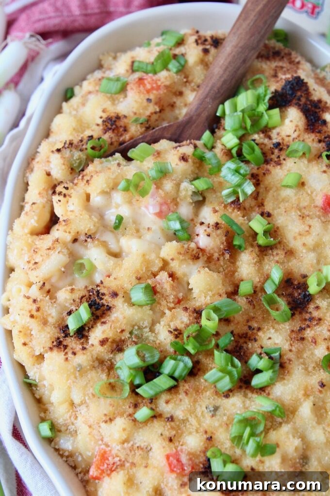 baked macaroni and cheese in dish with serving spoon