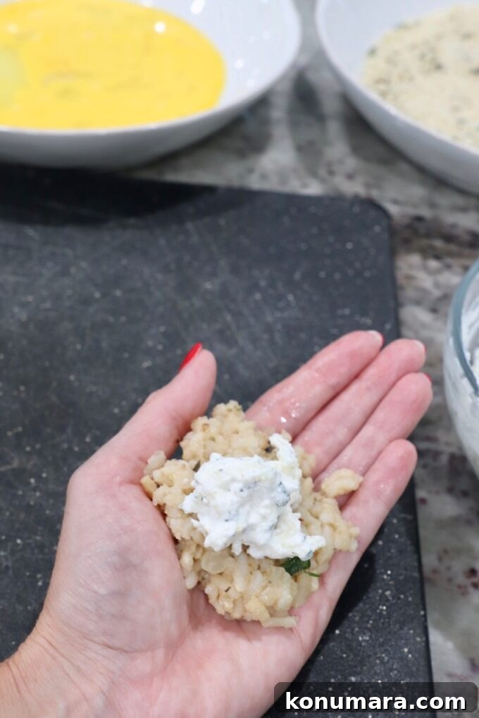 hand holding risotto with cheese on top