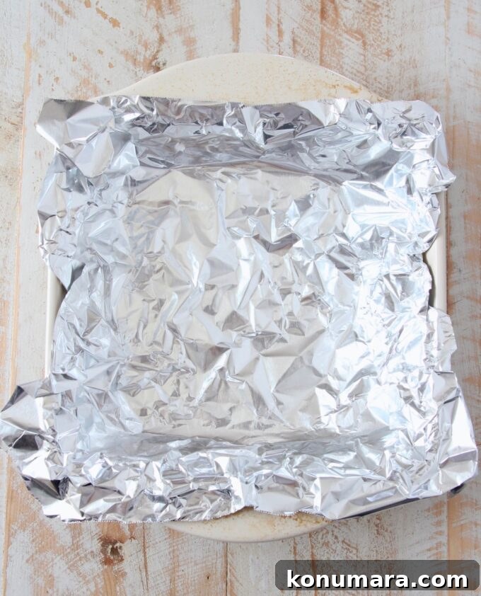 a piece of foil pressed into a square baking dish