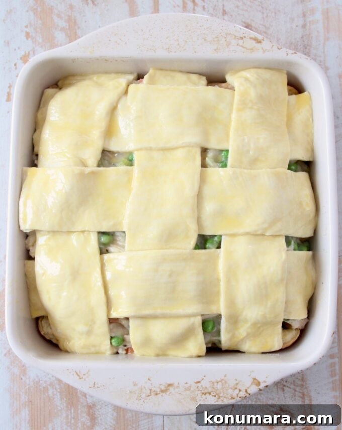 woven puff pastry crust over a pot pie in a square baking dish