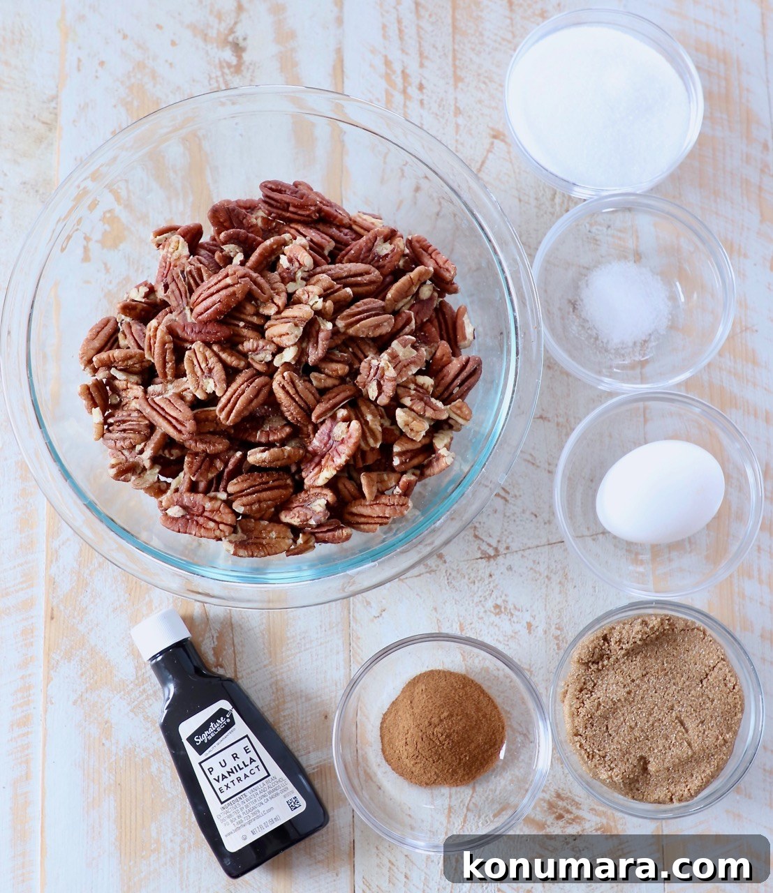 ingredients for candied pecans on white wood board