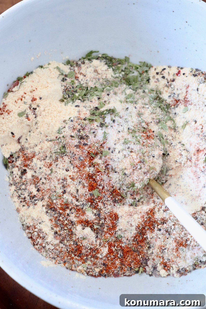 chicken seasoning mixed together in white bowl with spoon