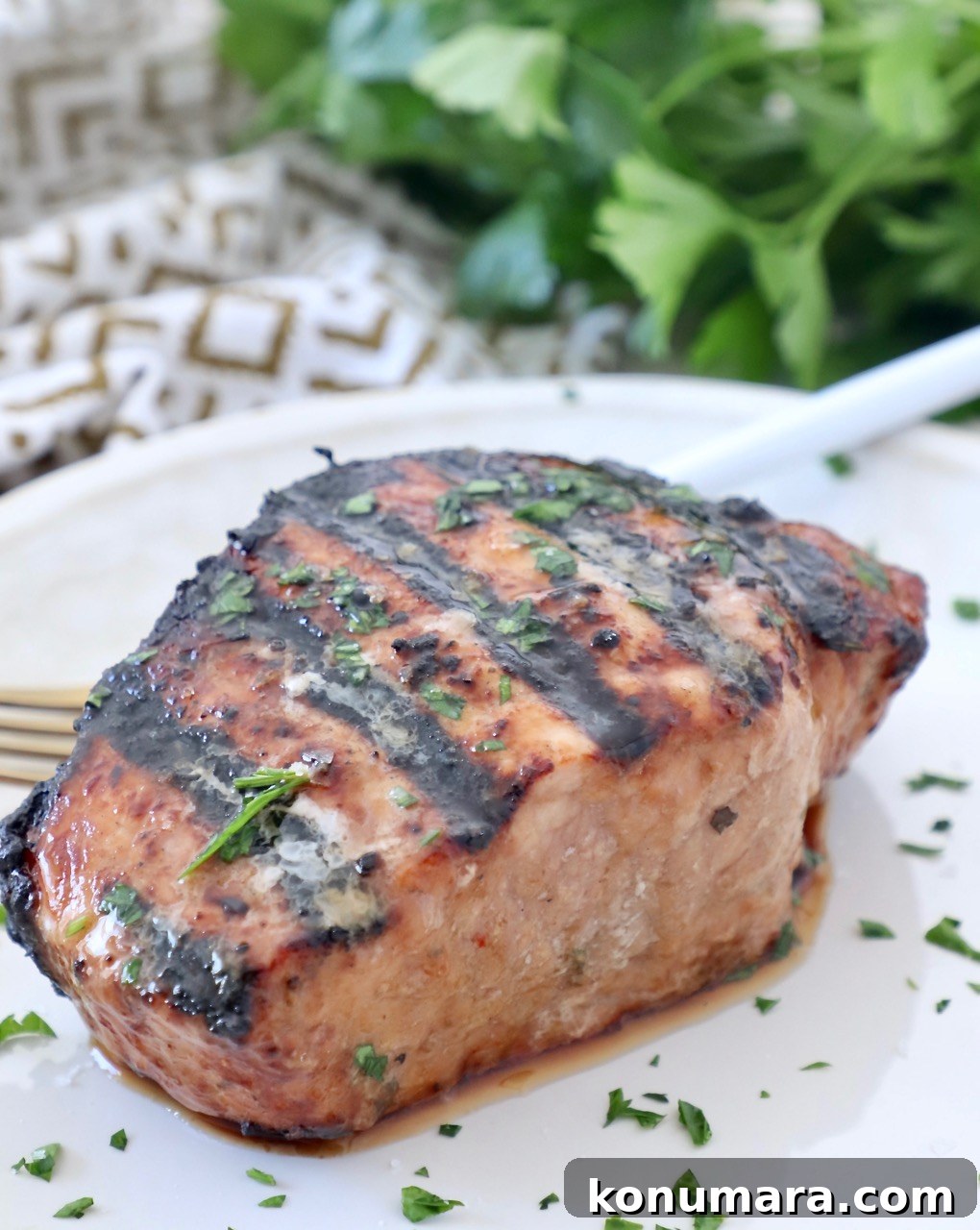 grilled pork chop on plate with fork