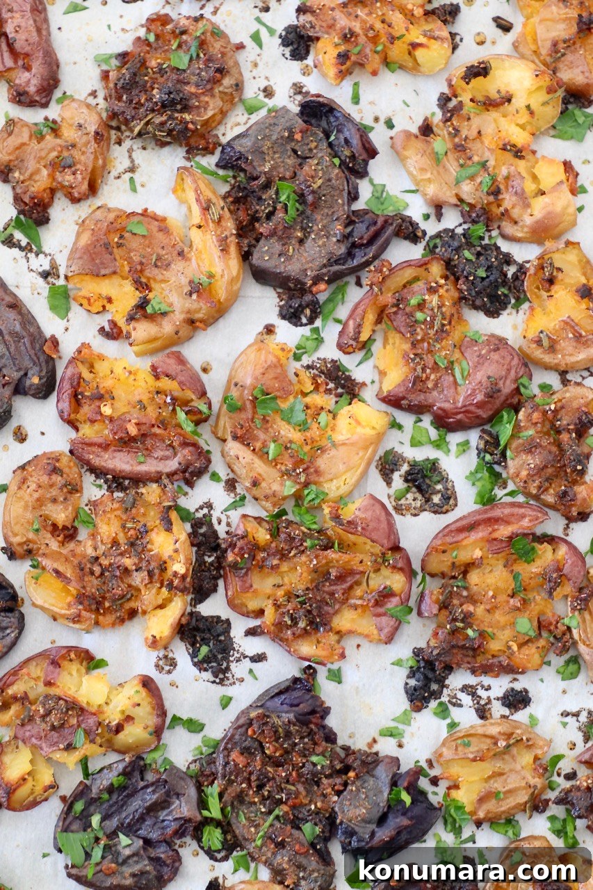 Crispy Smashed Potatoes Recipe with Garlic and Herbs 2 smashed potatoes on a baking sheet